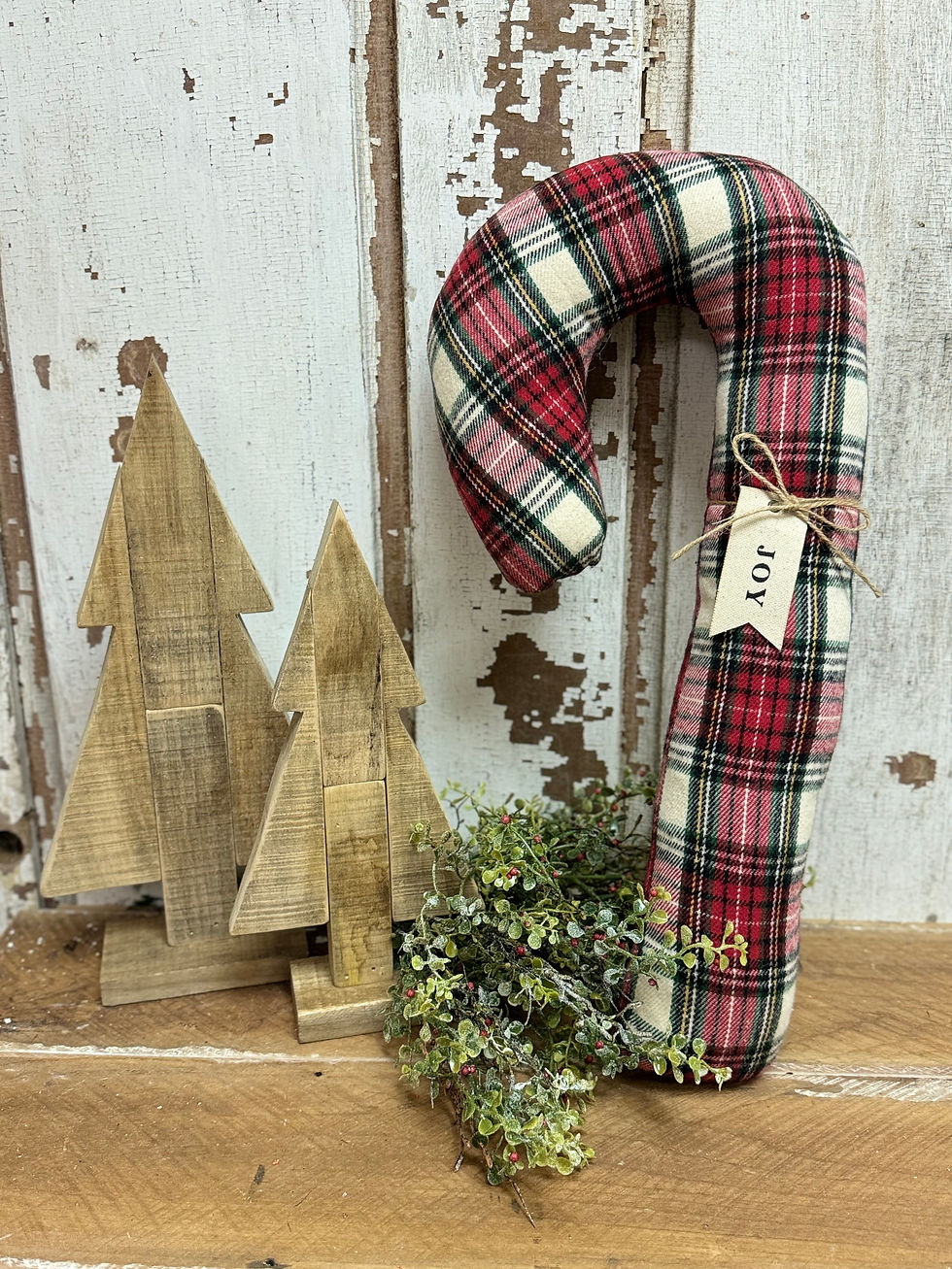 19.5" H x 9" W x 2.5" D candy cane shaped pillow in red plaid flannel, tag that says JOY