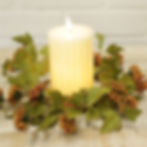 4.5" inner diameter candle ring of rusty oranges & golden yellow clusters with green foliage, great for fall