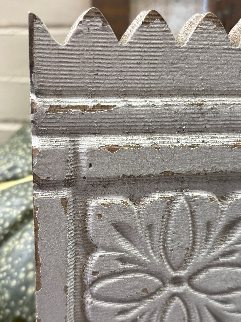 Thumbnail: 12" x 5" wood block with carved details, painted a chippy gray, iron double hook on bottom, 2  back loops for hanging
