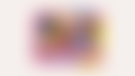 A hand holds colorful abstract shapes, charts, and papers. A small plant is in the foreground. Vibrant colors evoke a creative mood.