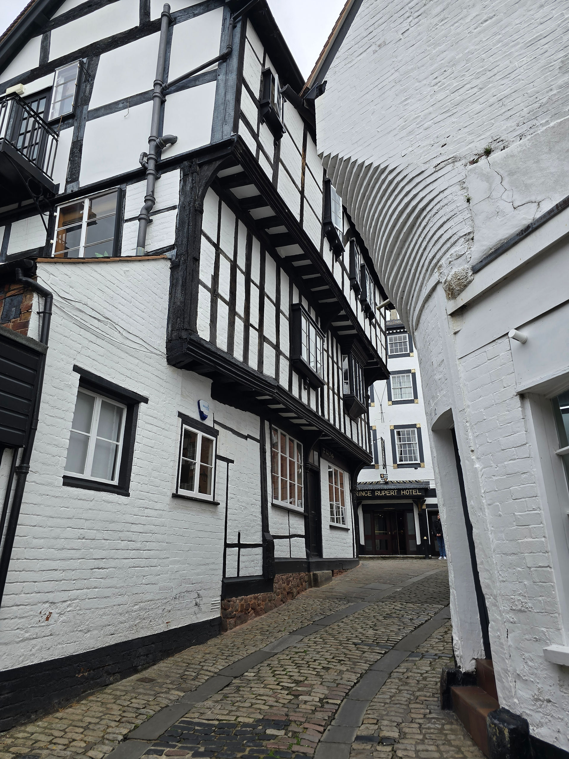 Tudor buildings overhang the cobbled street in this view towards Butcher Row.