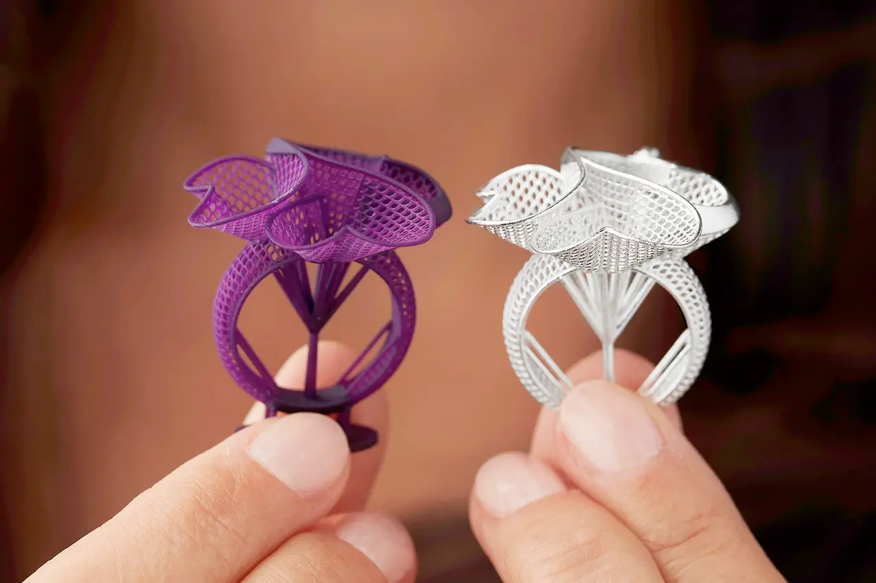 A 3D-printed jewelry prototype next to the finished product