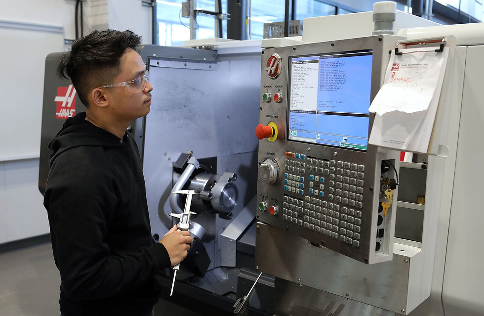 A machinist adjusting the CNC machine settings