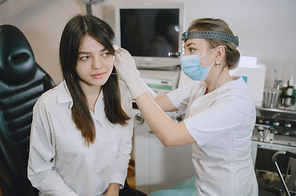 woman-patient-medical-office-doctor-medical-mask-lor-checks-woman-ears.jpg
