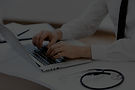 "Healthcare professional typing on a laptop with a stethoscope visible, featuring overlay text 'Our Blogs' and a blue"