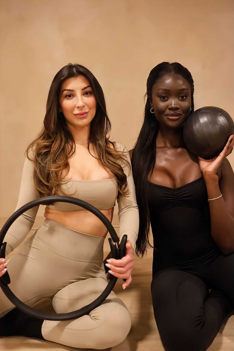 Two members holding a Pilates ring and ball at Afitness Pilates, a women only studio in St. Albert