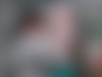 A father in tears embraces his young daughter, dressed in a pink coat and hat, after reuniting at the border amid the Ukraine war.