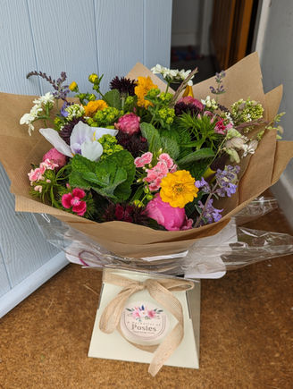 A bouquet of seasonal British-grown flowers placed at the entryway of a front door