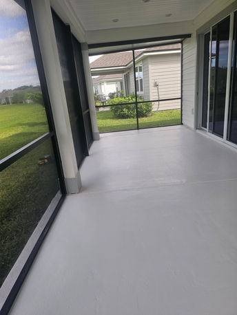 Modern screened-in porch with light gray flooring.
