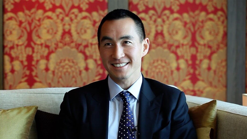 A headshot of Lawrence Ho, founder and CEO of Melco Resorts, smiling.