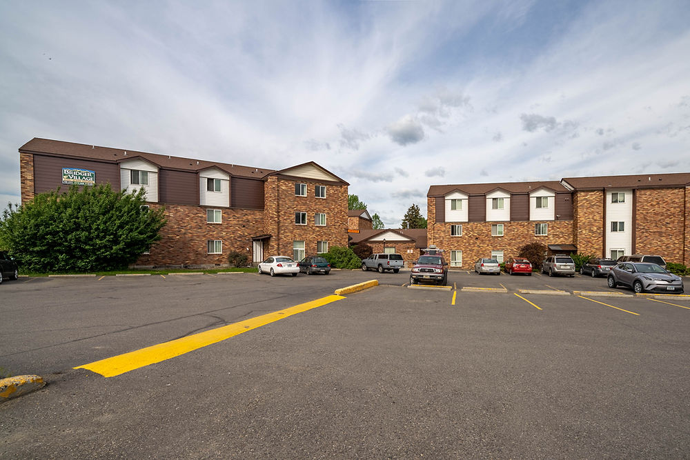 Bozeman apartments with brick buildings and a parking lot