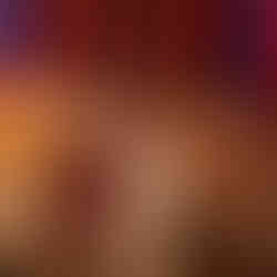 Two cats are sleep together on a couch