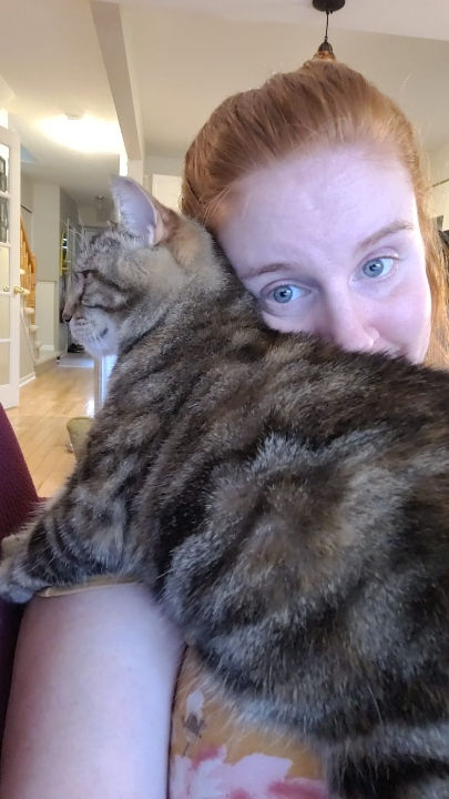 Cat sitter and Affie the cat enjoying a nice cuddle session at Priority Pet Boarding Services inc.  