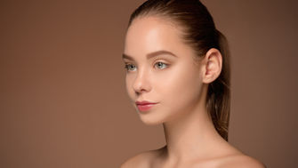 image of woman in her 30's with healthy, youthful skin