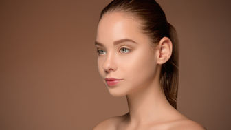 image of woman in her 30's with healthy, youthful skin
