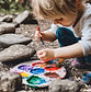 child painting rocks outside.jpg