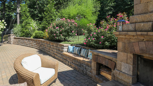 Outdoor stone patio with seating area, perfect for backyard entertaining.