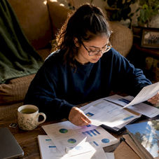 Student reviewing college acceptance documents at table
