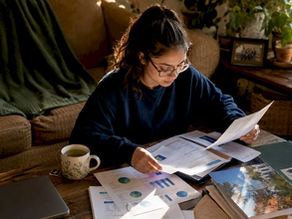 Student reviewing college acceptance documents at table