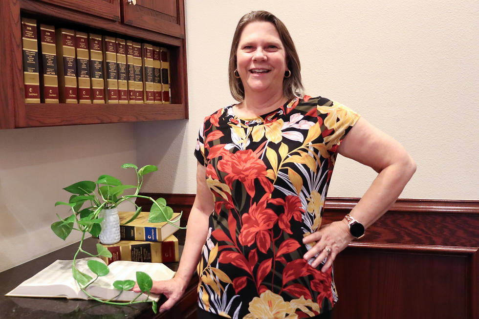 Michelle, experienced paralegal and legal secretary, smiling confidently in a professional headshot.