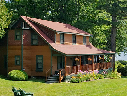 Sideview of Cabin 5 with ADK chairs and the garden