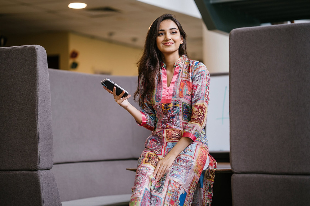 A woman checking her blood sugar using the Diabits app while at work