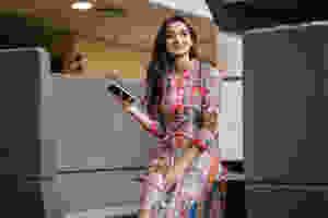 A woman checking her blood sugar using the Diabits app while at work