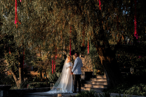 Bride and groom posing with scenic background at Casa Cien wedding in San Miguel de Allende.