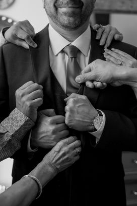 Black and white wedding detail with groom and his brothers hands during getting ready