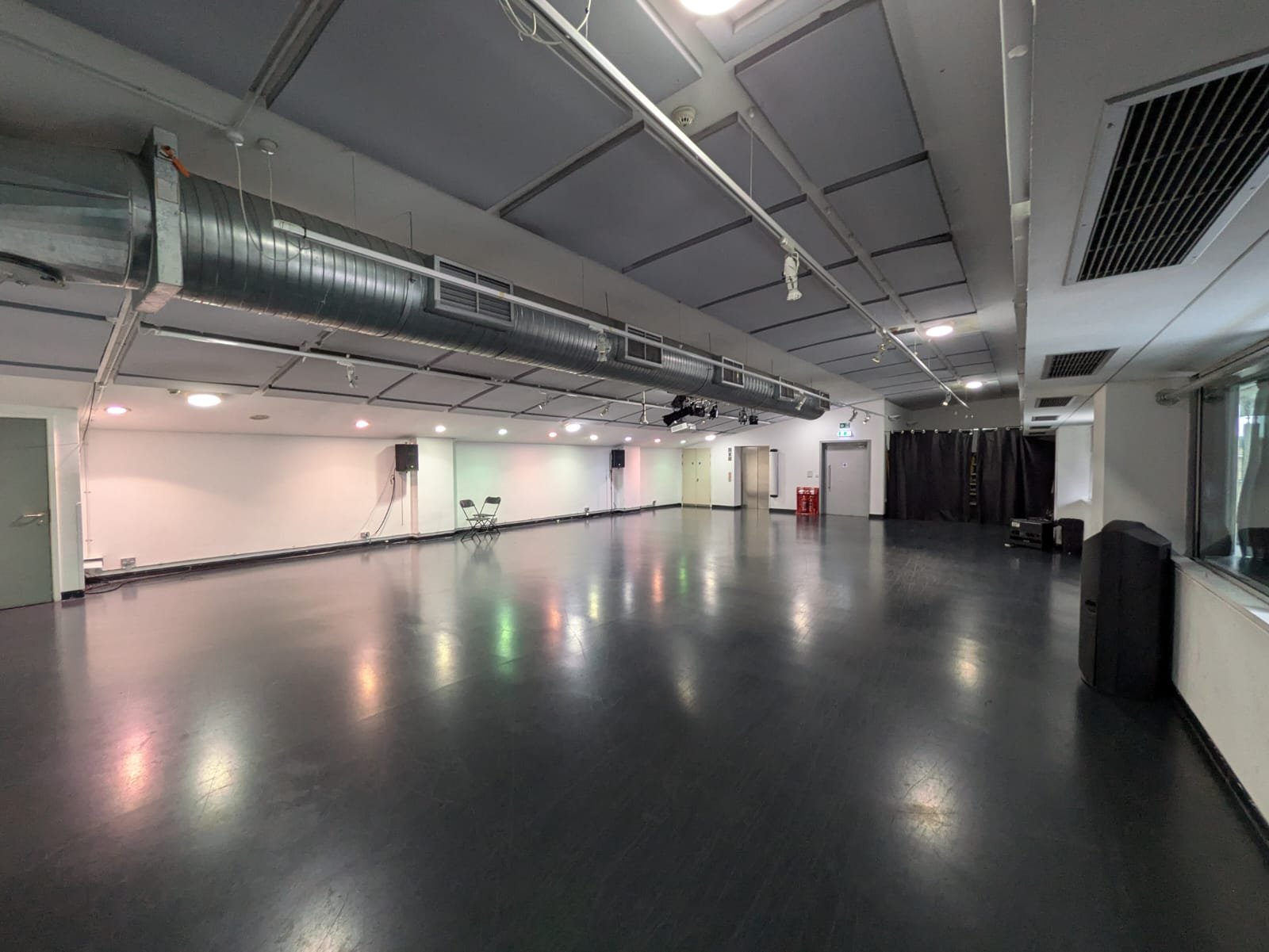 The Mix: a long, open, empty room with a dark floor.