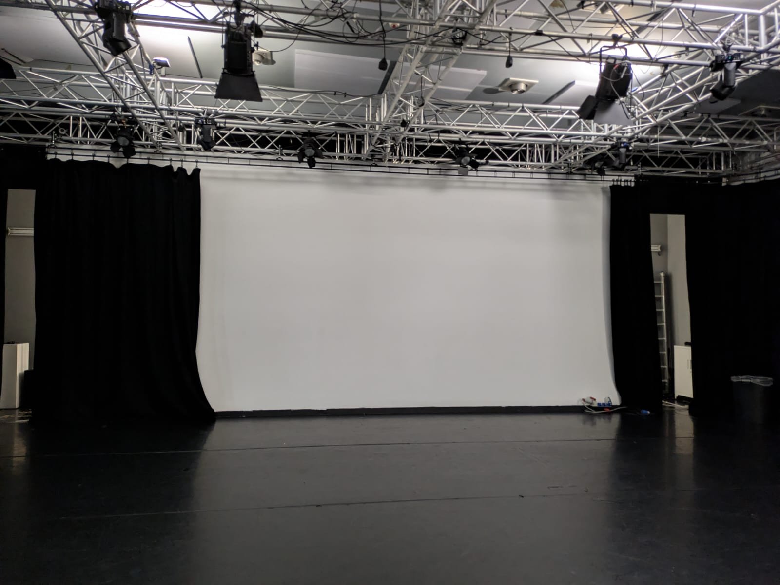 The Studio: a large empty room with a screen at the front.