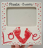 picture frame with the words love written at the bottom, the letter v is created with two footprints