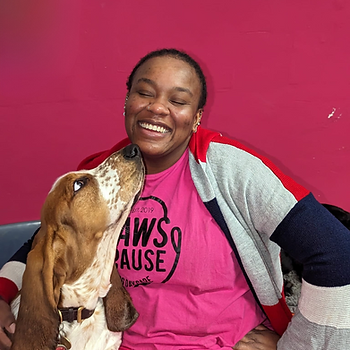 A girl smiling with a basset hound