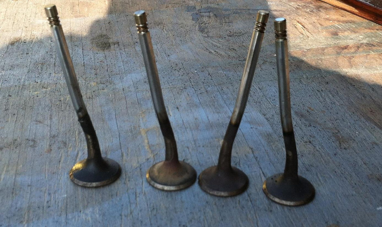Bent valves removed from a cylinder head after a timing belt failure