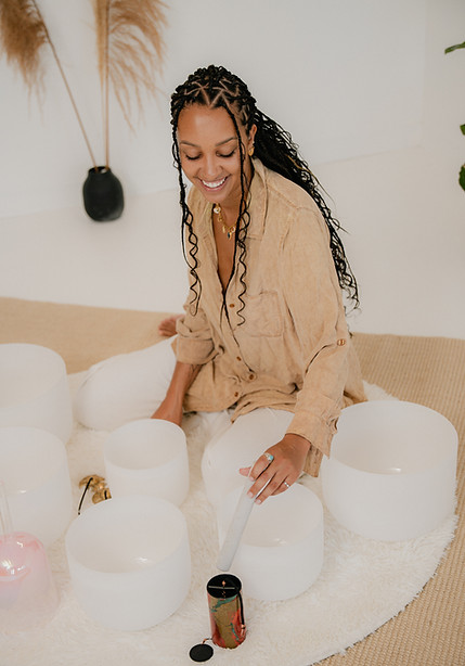 Sound bath practitioner facilitating a healing session with crystal singing bowls.