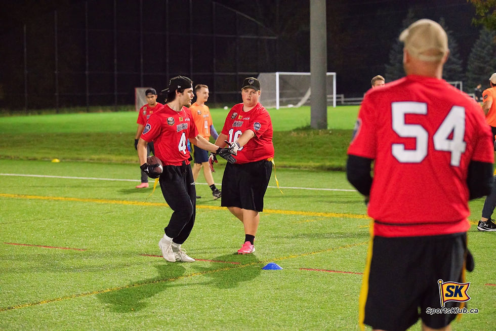 Rick Grant of Rick Grant Landscaping Blues watching Hayden Woodbeck and Aiden McMaster celebrate a touchdown during SportsKlub Orillia Flag Football action at the West Orillia Sports Complex on Monday night.