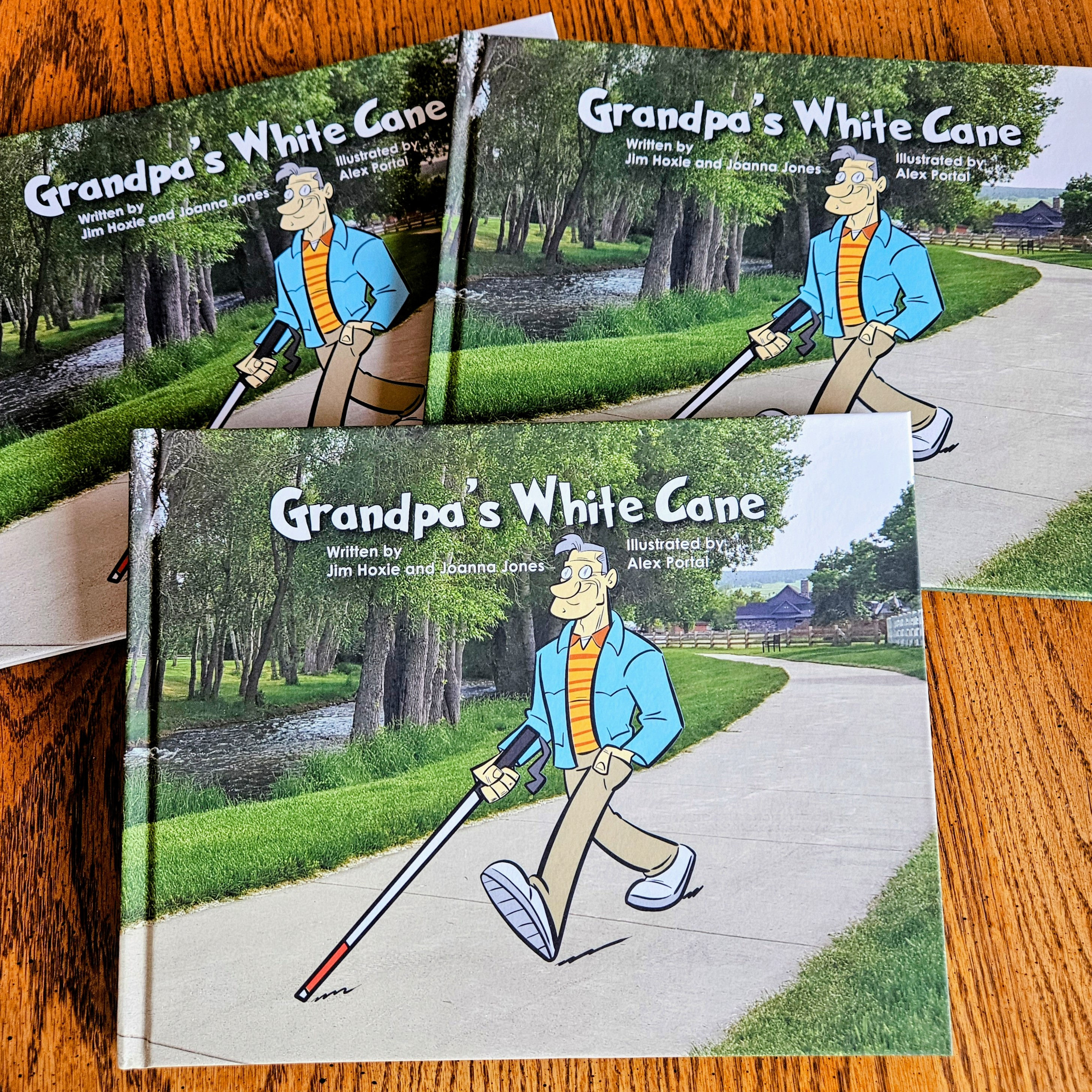 Stack of 3 Grandpa's White Cane Hardback Book on a wooden table