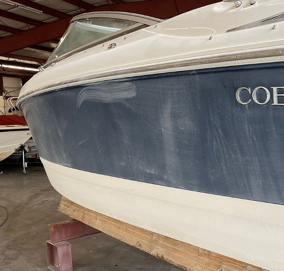 Oxidized blue Cobalt boat hull before gelcoat restoration by The Mobile Boat Guys in Seattle using the LAMICS™ system — photographed at North Lake Marina.