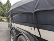 Severely oxidized black boat hull showing dull gelcoat surface before restoration and correction work