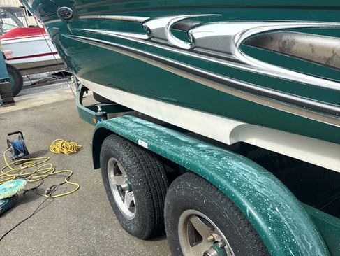 Sea Ray hull showing temporary gloss improvement after light correction