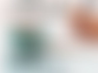 A seafoam green coffee cup is in front of a hand holding a pen writing in a notebook. The text reads, "WHAT I'M UP TO..." and the date.