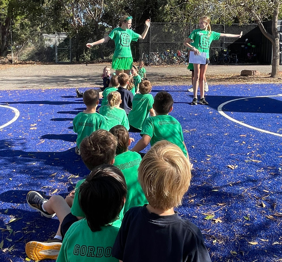 Students leading a House activity with younger students