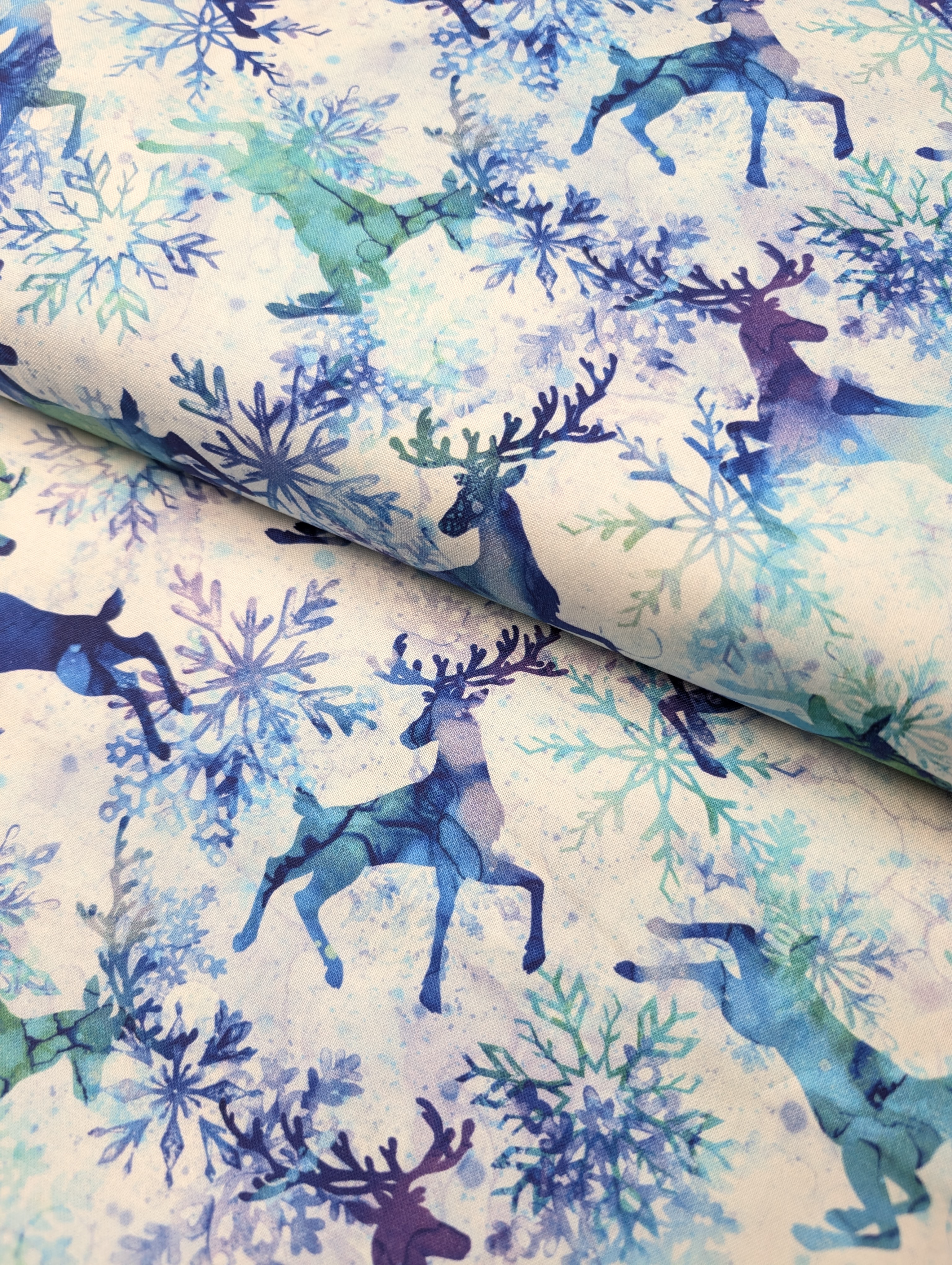 A collection of neatly folded high-quality cotton fabrics showing varied textures and woven patterns.