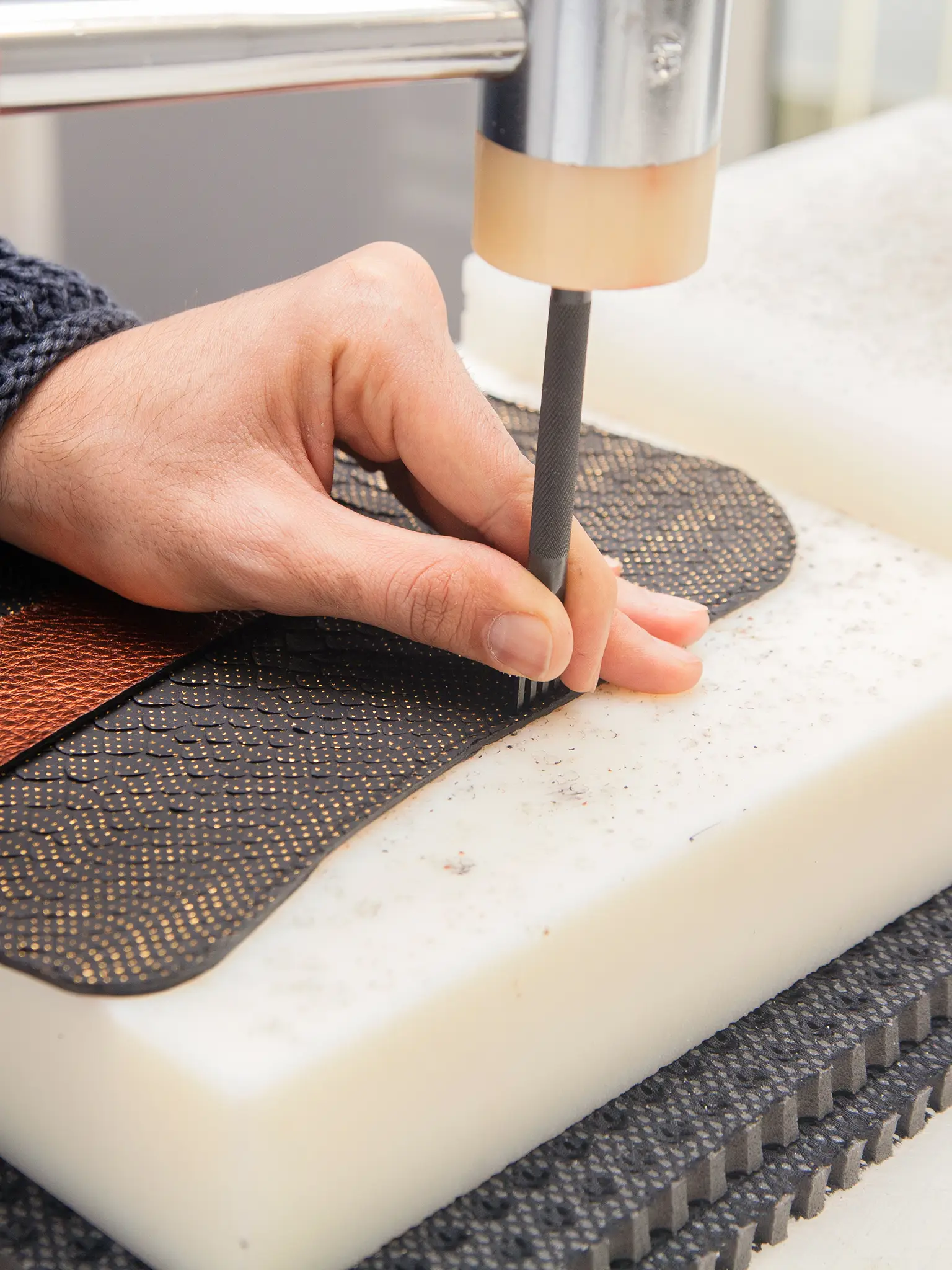 florentine artisan making holes in leather for hand stitching