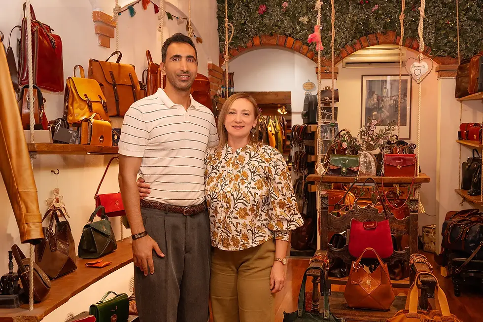 owner of the FLORENCIA LEATHER STORE standing in their store