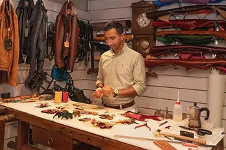 italian artisan making by hand leather souvenir in the leather store in florence.webp