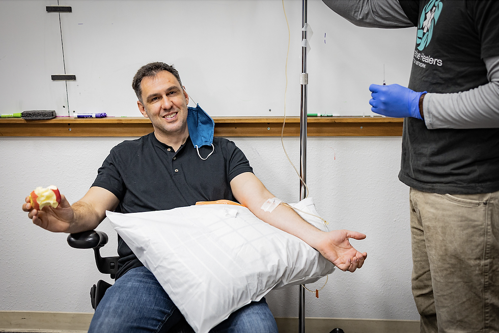 Fire Chief Shepley Schroth-Cary of Gold Ridge Fire District sits with a pillow on his lap and an IV in his arm participating in the detox program.