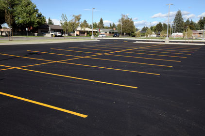 A newly completed parking lot with freshly painted yellow lines to mark the stalls..jpg