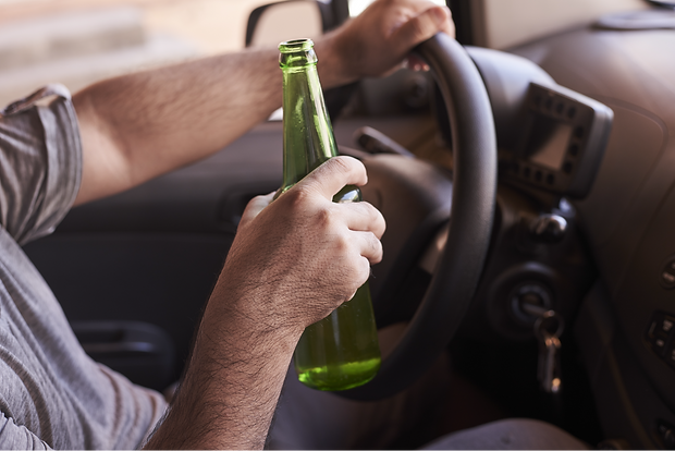 bottle-beer-man-s-hands-driving-car-daytime_edited.png