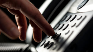 An operator at a medical call center practices safe emergency communication.